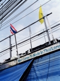 Made in Thailand. Thai and Royal flags with phone and electric wires.