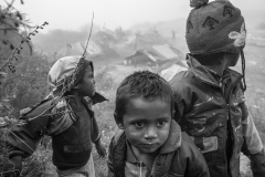 Sandesh and his buddies hang around the camp in the morning mist. They have no schooling and the camp surroundings are for them a place for explorations.