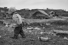 For toys anything goes: a little man plays beside his tent. Like the other children of the camp, he sometimes feels a profound sense of loneliness.